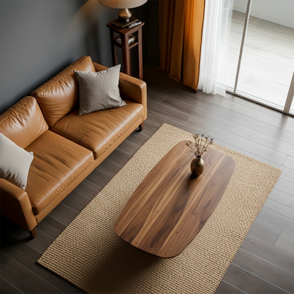 Walnut tone coffee table with flowing base structure and seamless surface in a soft neutral interior