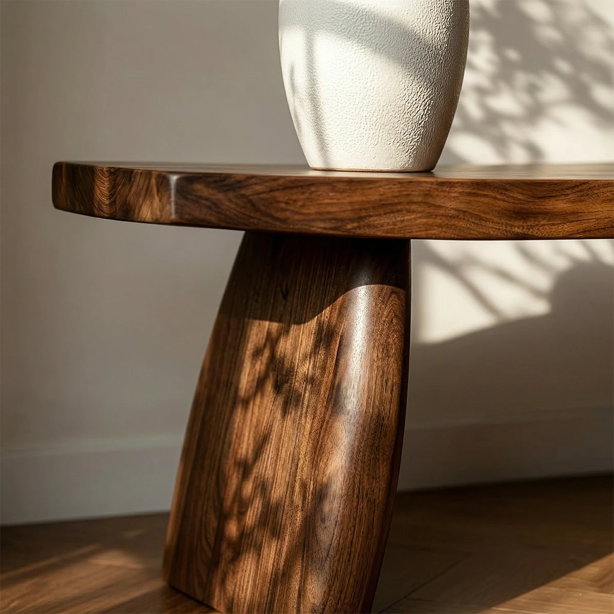 Contemporary seating bench displaying curved architectural shape and polished walnut tone finish