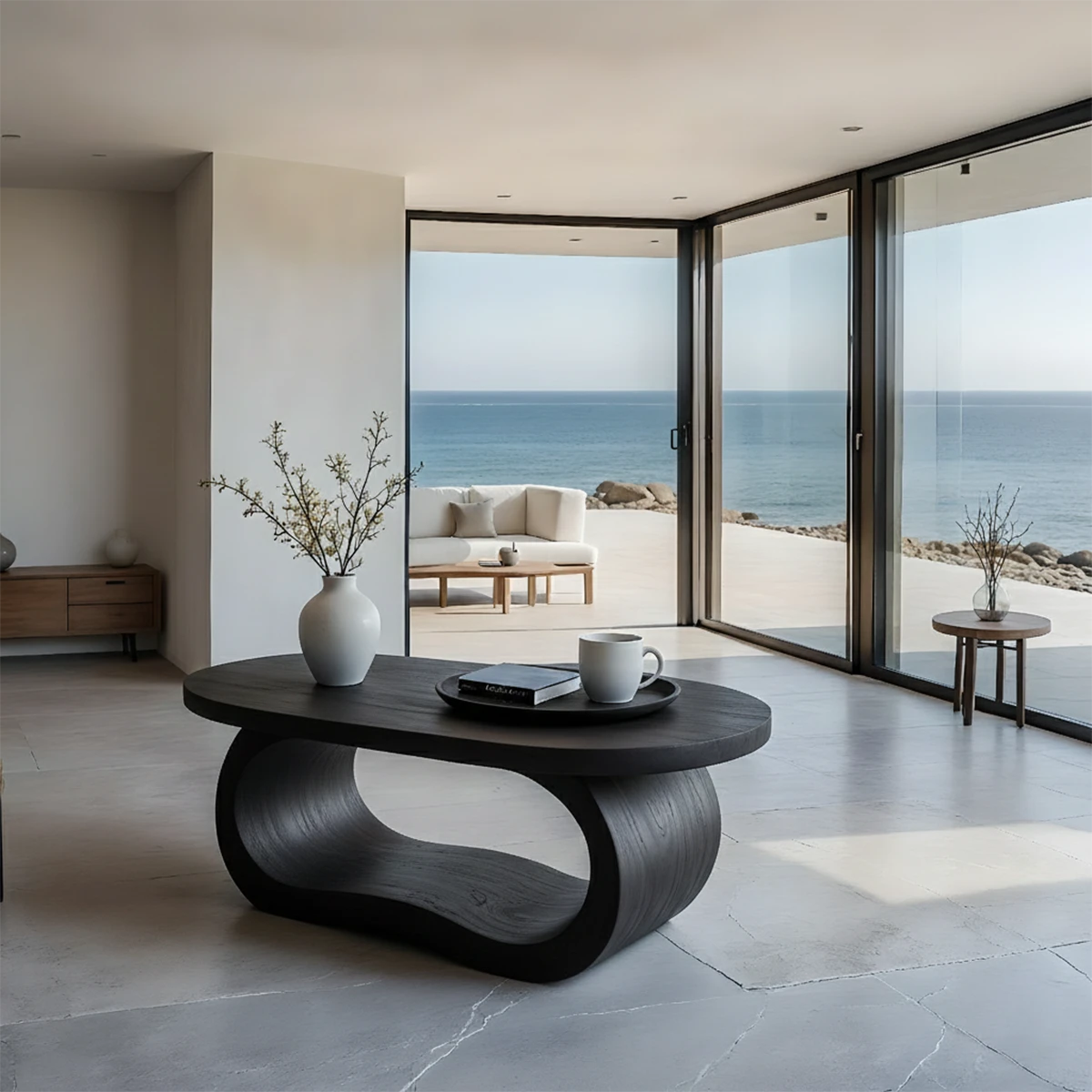 Black look coffee table with organic silhouette and smooth surface in a minimalist styled living room