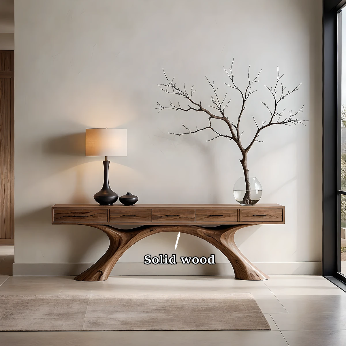 A natural wood console table with smooth curved supports adds warmth to this minimalist space