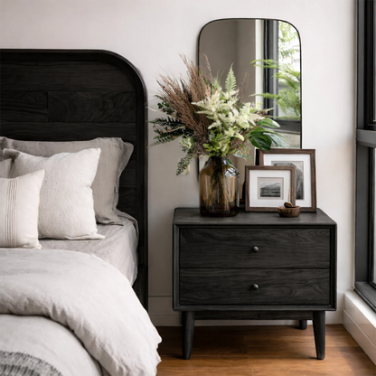 Space saving bedside table designed with clean surfaces and smooth black tone finish
