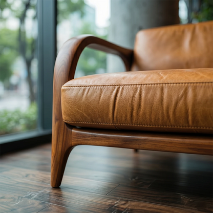 Minimalist 3 seater sofa with smooth leather upholstery and natural wood base in modern interior