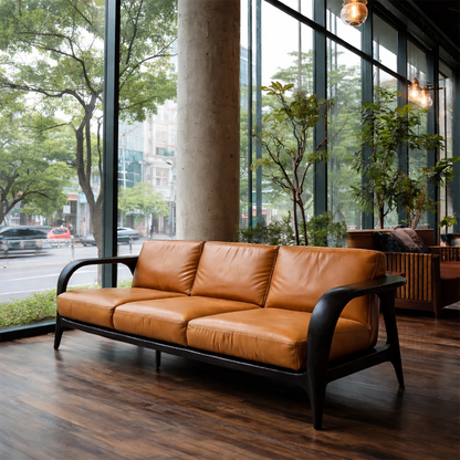 Designer three seater sofa with curved armrests, leather upholstery and warm modern ambiance