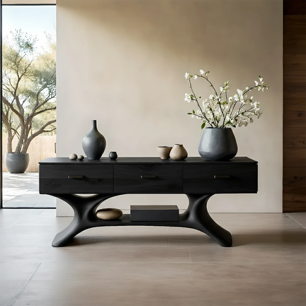 Sleek hallway table with sculpted wood base and storage drawers in bright architectural space