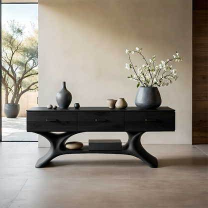 Sleek hallway table with sculpted wood base and storage drawers in bright architectural space