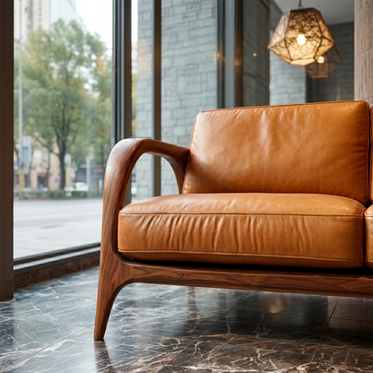 Minimalist three seater sofa with soft leather upholstery and clean natural wood base near large windows