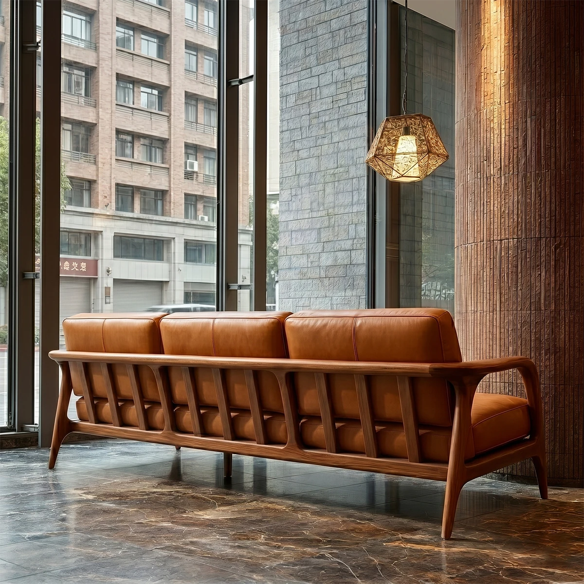 Elegant modern sofa with curved wooden arms, plush leather cushions and open airy interior setting