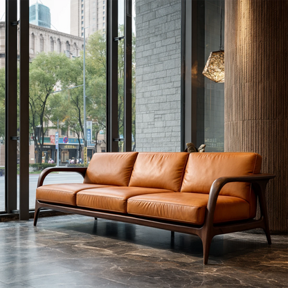 Sleek modern sofa with low profile, leather cushions and handcrafted natural wood frame in sunlit room