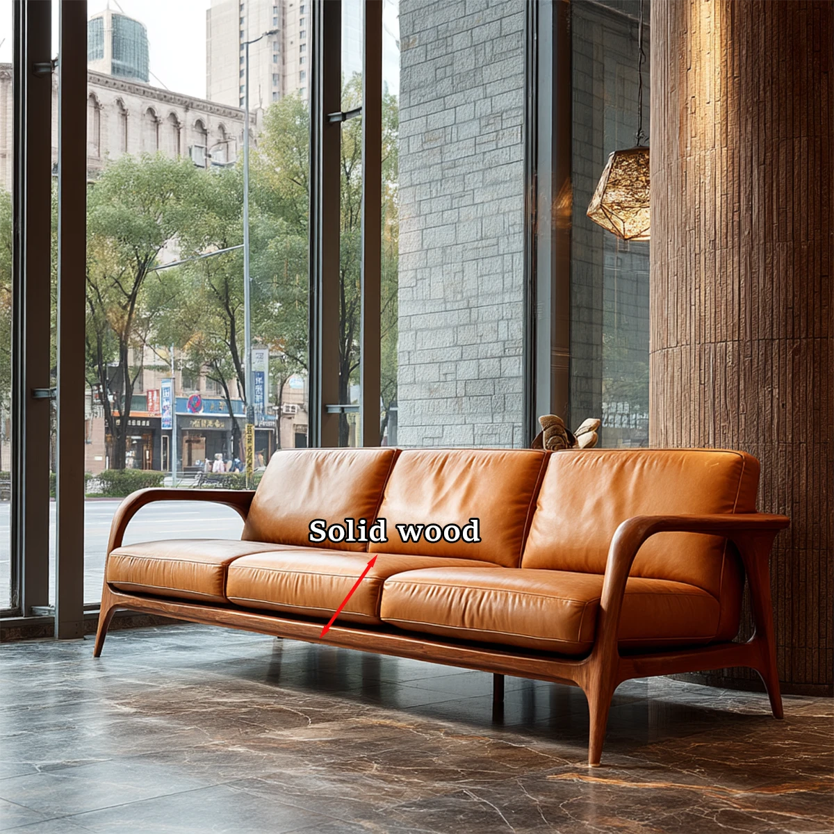 Modern minimalist sofa with curved wood arms and smooth leather cushions placed beside large glass windows