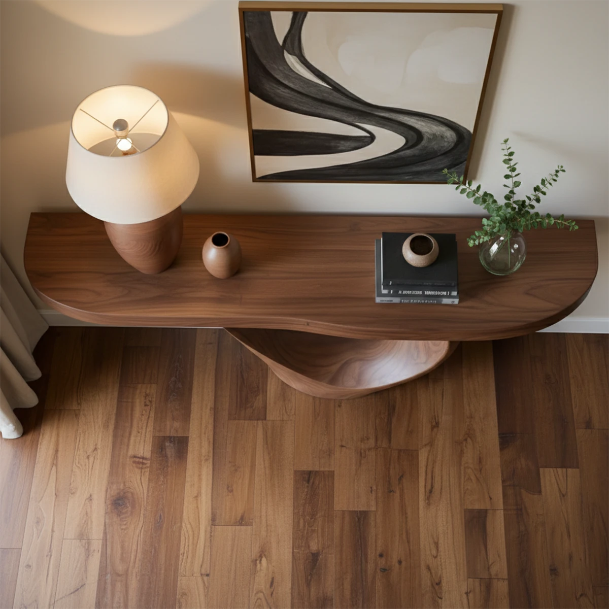 Elegant console table with sculptural wood base enhances this clean and softly lit interior