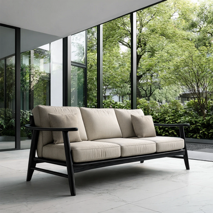 Designer sofa with neutral upholstery and exposed wood frame placed in modern architectural space