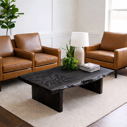 Coffee table in matte black finish with artistic base design and soft curves in a bright interior