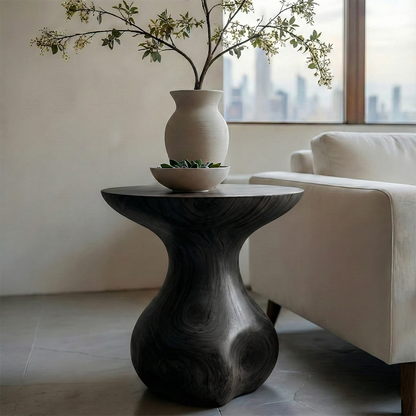 A small end table in black color with curved form for compact and functional spaces