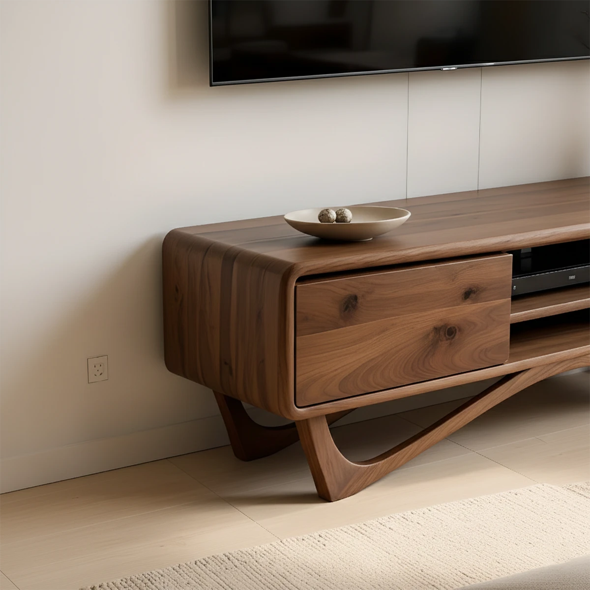 Designed with a walnut color finish, the TV stand highlights soft edges and balanced proportions