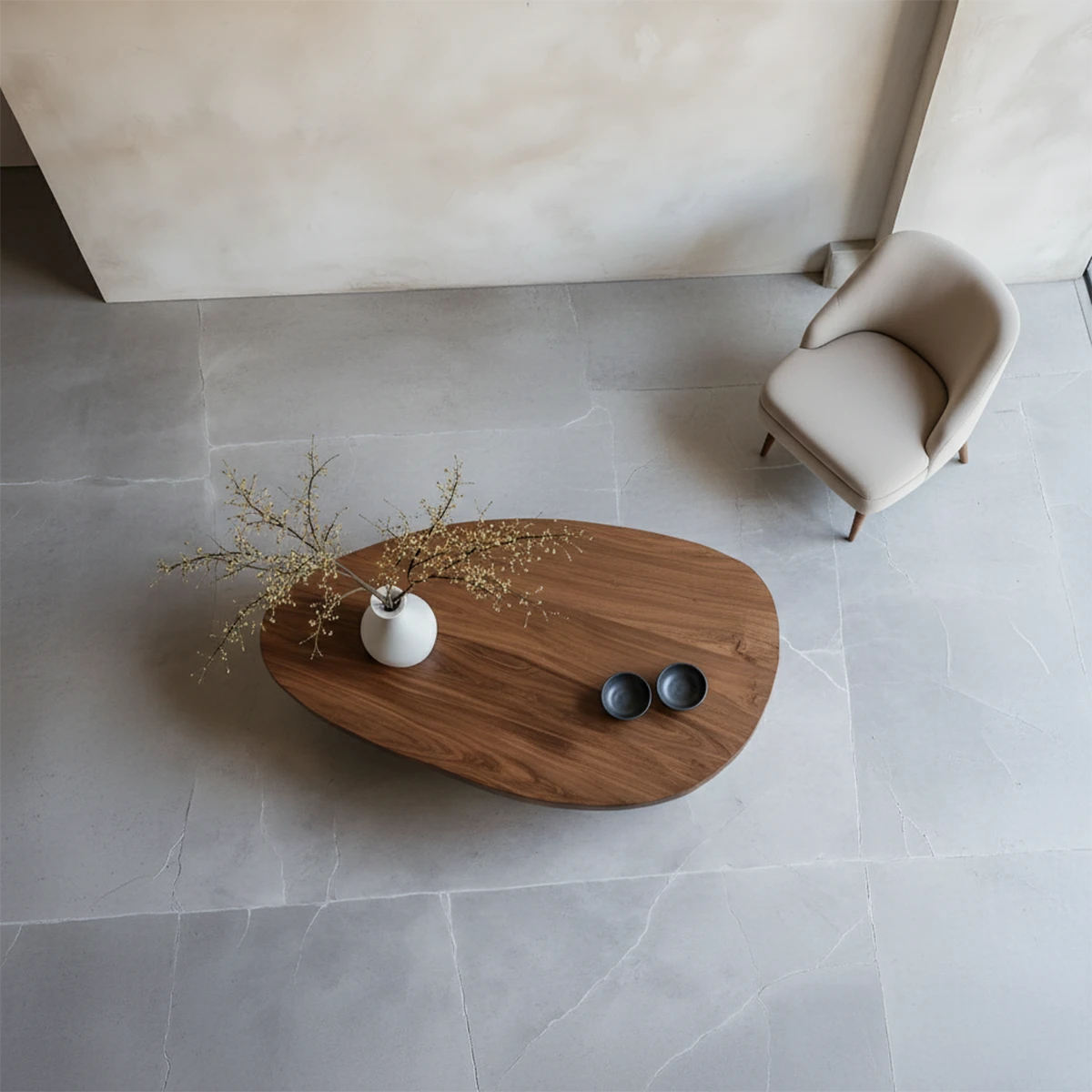 Walnut coffee table with artistic sculptural base and natural flowing shape placed in minimalist interior setting