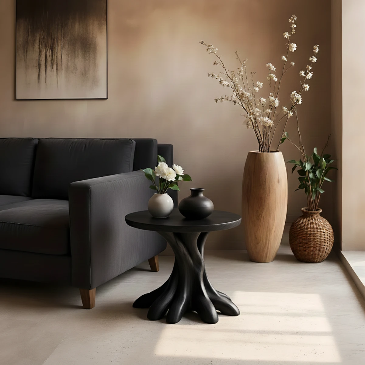 A compact round end table in black color with organic base for small functional spaces