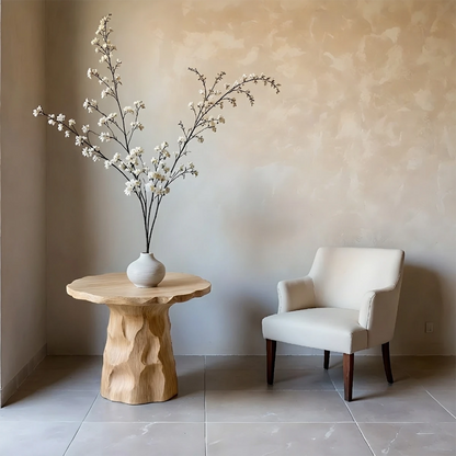 A compact round end table in oak color with carved base for small functional spaces